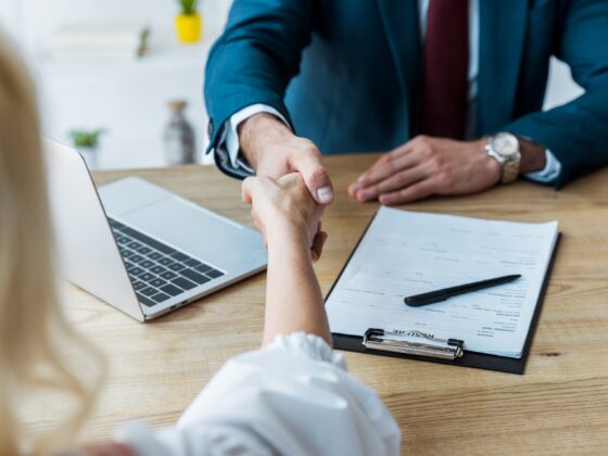 selective focus of employee and recruiter shaking hands