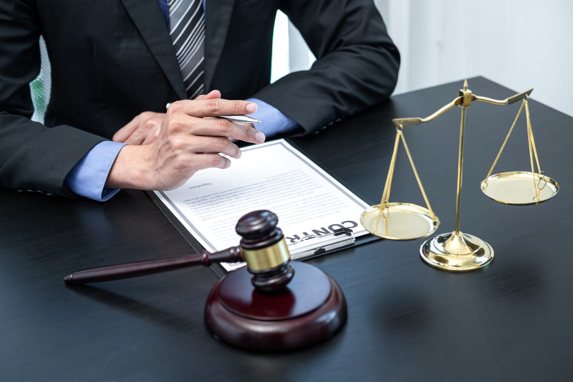 Male lawyer working with legal case document contract in office