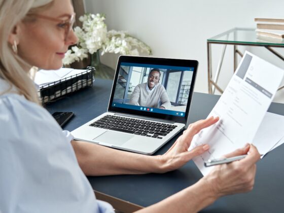 Female hr reading cv during online virtual job interview by video call.