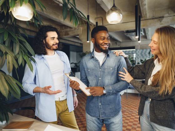 Office work team greeting their new african american male employee
